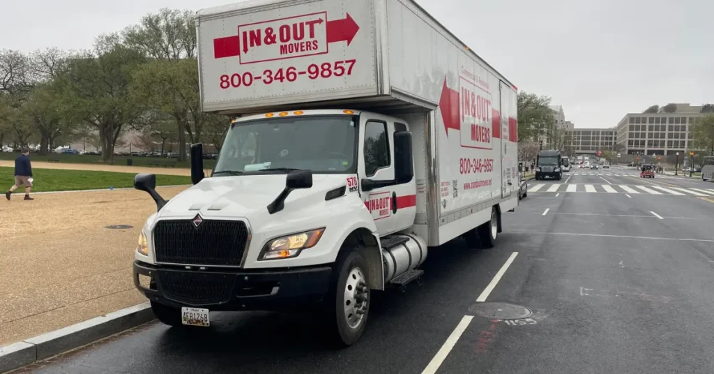 In & Out Movers truck parked on a city street, advertising moving services for in town movers with phone number 800-346-9857.