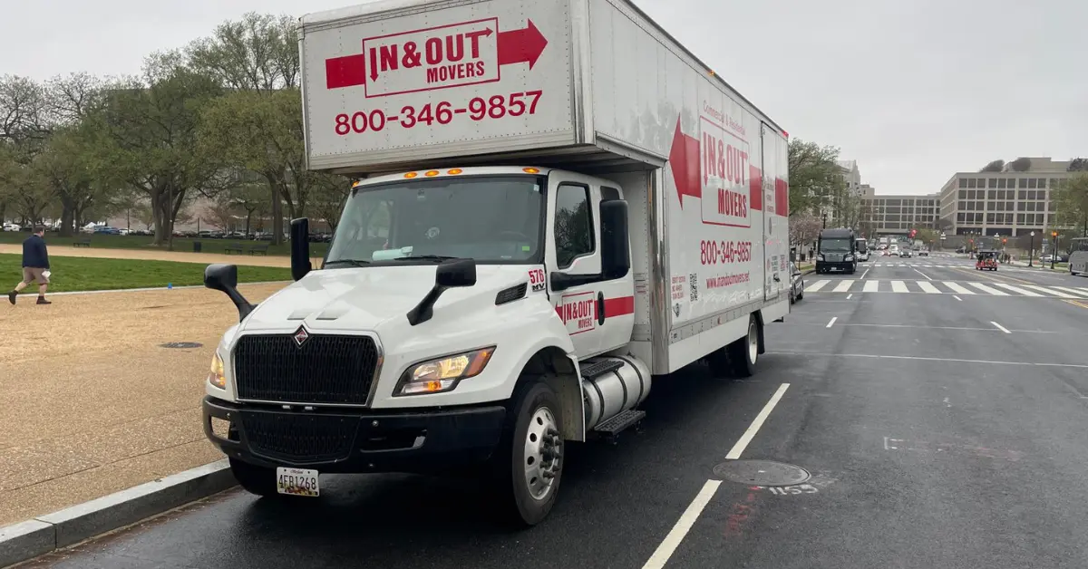 In & Out Movers truck parked on a city street, advertising moving services for in town movers with phone number 800-346-9857.