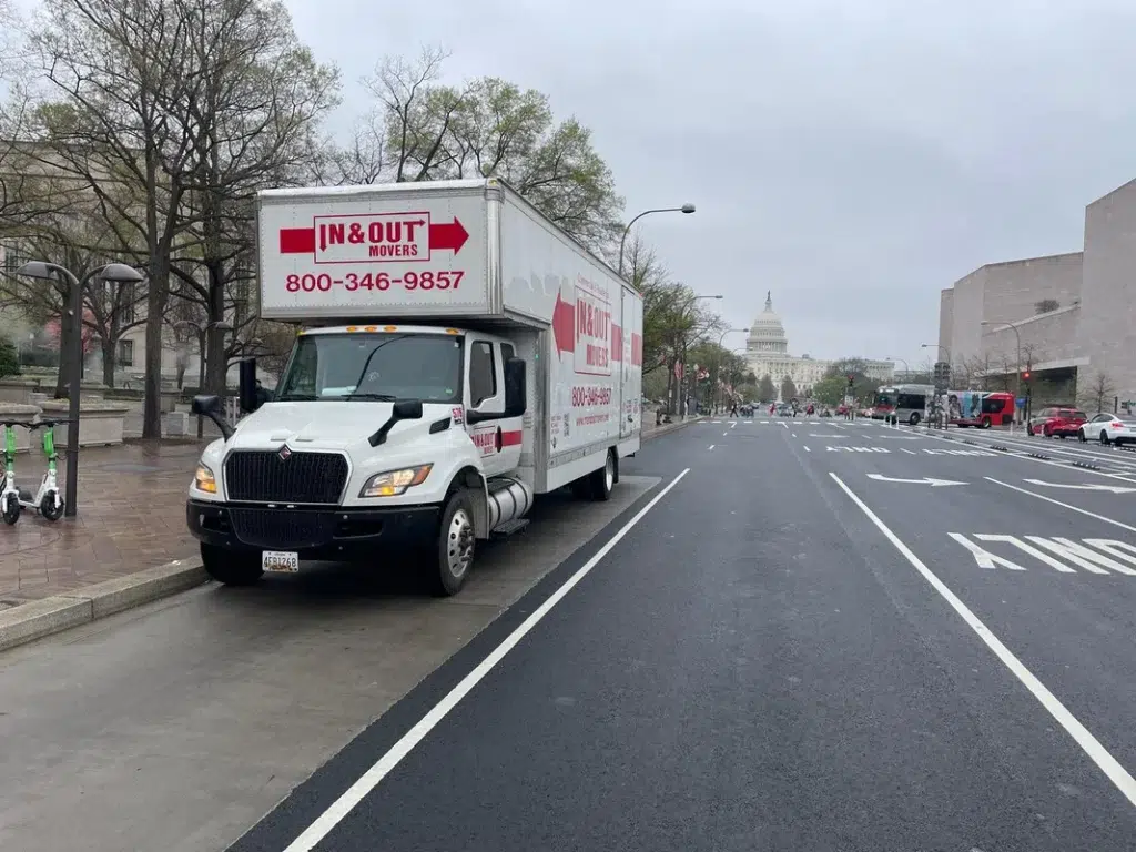 Branded In & Out Movers truck parked near US Capitol building