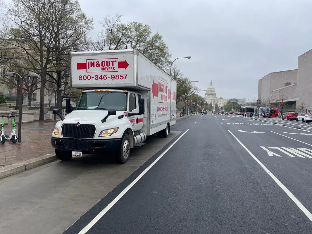 Branded In & Out Movers truck parked near US Capitol building