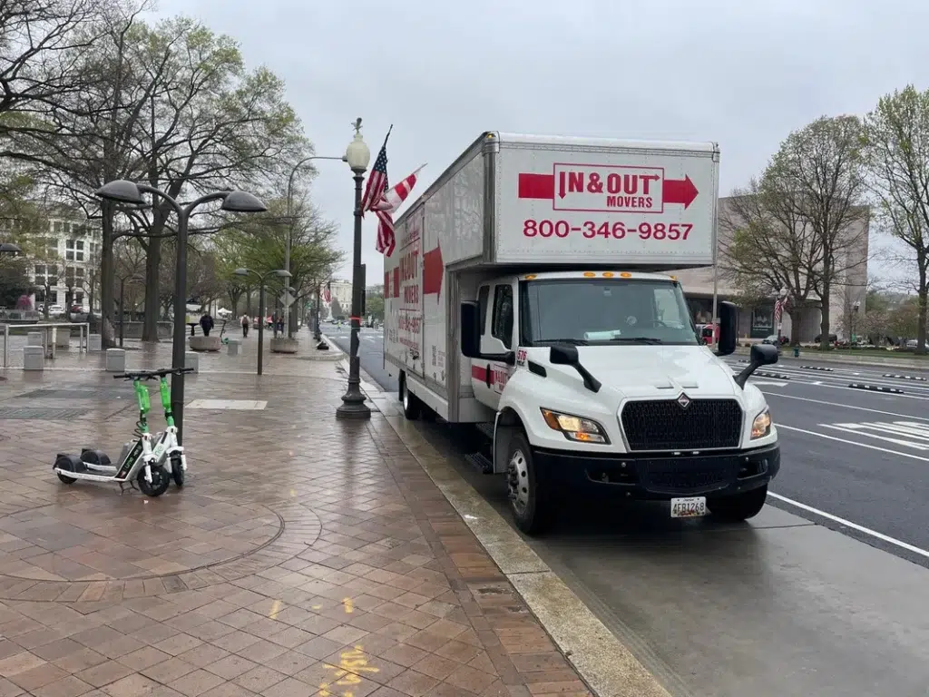 In and Out Movers branded box truck parked on city street in Arlington, VA