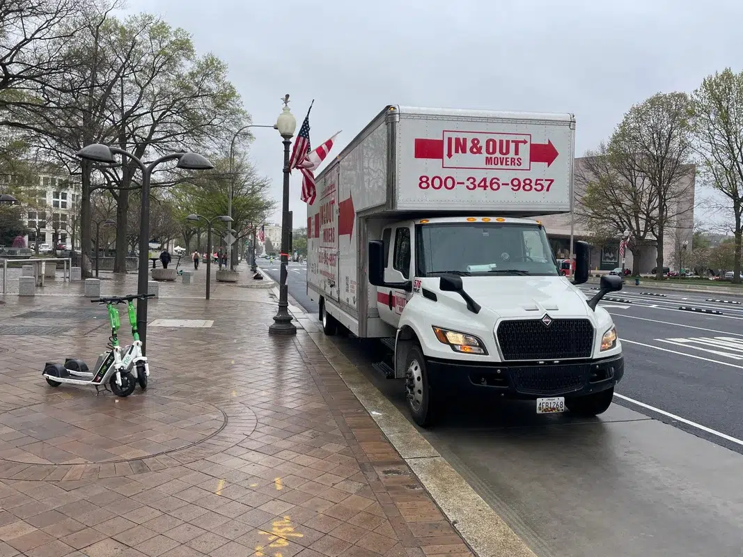 In and Out Movers branded box truck parked on city street in Arlington, VA