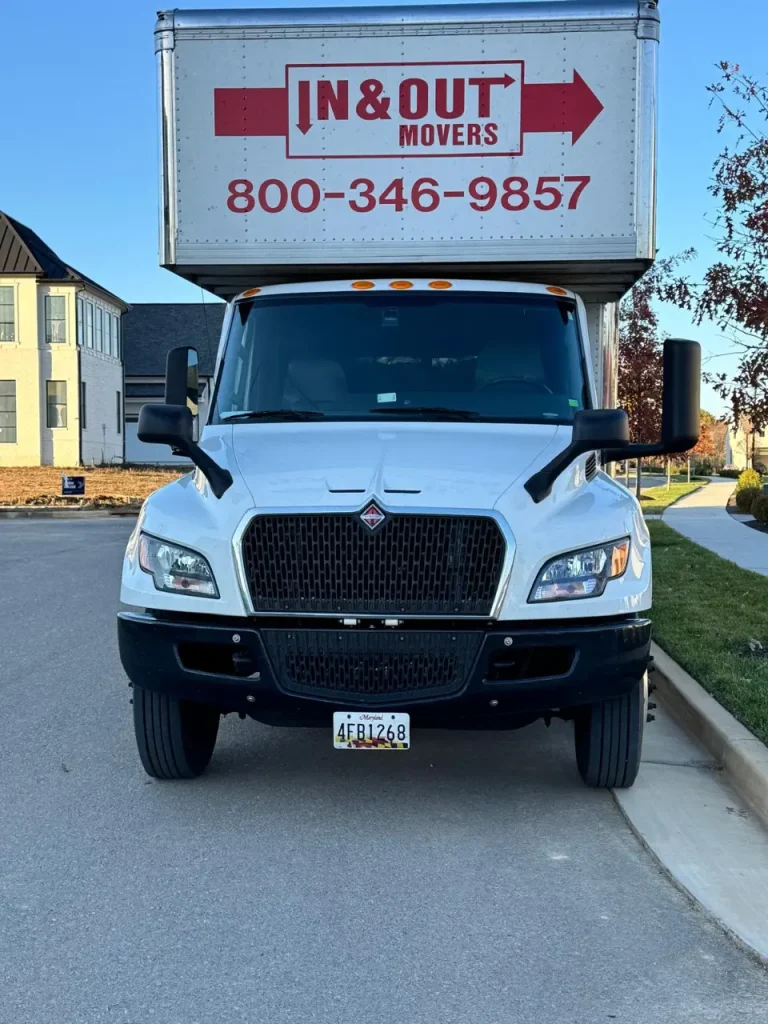 Front view of In & Out Movers truck with company branding and phone number for customers moving to Washington DC.