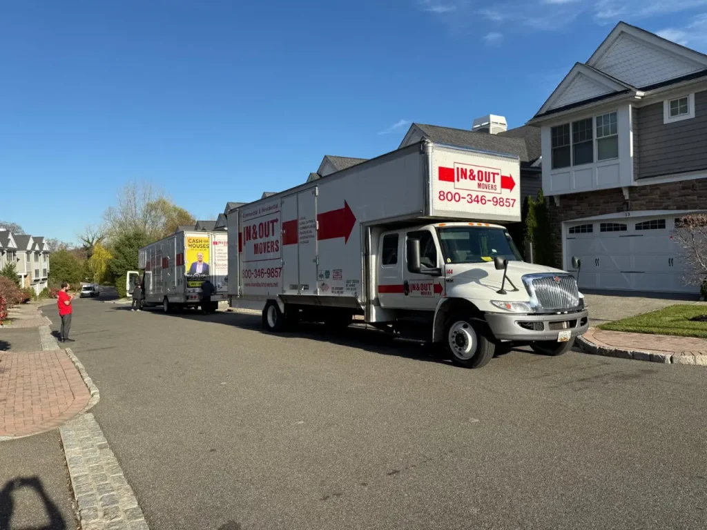 Professional moving trucks parked along a residential street during a family relocation, supporting moving with children.