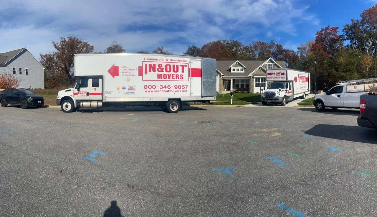 Professional moving trucks parked along a residential street during a family relocation, supporting moving with children.