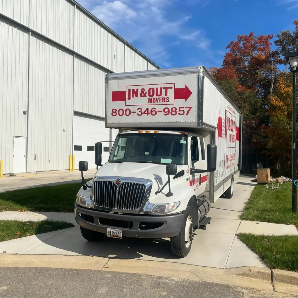 In & Out Movers truck parked beside a warehouse during a warehouse relocation project.